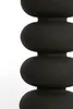 A close-up, studio shot of a black, stacked column-like object against a white background. Produktbild-Vorschau