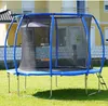 A trampoline is set up on a grassy lawn in front of a house. Podgląd zdjęcia produktu
