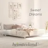 A bedroom scene with a bed, pictures on the wall, and a side table. Náhled obrázku produktu