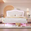 A bedroom with a white bed frame featuring a crown headboard with LED lighting. Anteprima dell’immagine prodotto