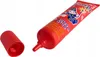 A red tube of puzzle glue with a wizard illustration and text is shown on a white background, with its red cap lying next to it. Podgląd zdjęcia produktu