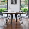 A dining room scene with a round table and chairs. Náhľad obrázku produktu