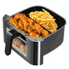 Close-up of an air fryer basket containing chicken wings and french fries. Podgląd zdjęcia produktu