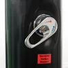 A close-up of a black solar shower with a silver faucet and a red warning sticker. Produktbild-Vorschau