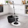 A spin mop and bucket set is displayed on a light gray tiled floor in a kitchen setting. Podgląd zdjęcia produktu