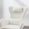A close-up view of a white, fluffy armchair with two pillows. Produktbild-Vorschau