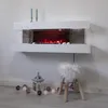 A modern white electric fireplace mounted on a white wall, with decorative elements on the hearth and floor. Produktbild-Vorschau