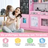 A mother and daughter are playing with a pink wooden toy kitchen. Produktbild-Vorschau