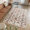 A living room scene with a couch, rug, and coffee table.