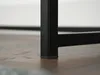 A close-up of the black metal leg of a console table resting on a wooden floor. Produktbild-Vorschau