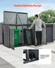 A man is placing a trash can into a storage shed. The shed is designed to hold multiple trash cans and has a ramp for easy access. The image is set outdoors with trees and a blue sky in the background. Podgląd zdjęcia produktu