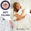 A woman is lying in bed, hugging a pillow and looking content. The image is overlaid with text and graphics promoting a soft filling. Voir les images du produit
