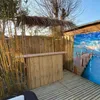 A bamboo bar setup on a wooden deck, with a tropical mural in the background. Produktbild-Vorschau