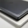 A close-up shot of two protective cases for a laptop, one dark gray and the other white, stacked on top of each other. Produktbild-Vorschau
