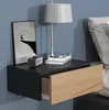 A wall-mounted nightstand with an open drawer, a lamp, and a framed picture. Produktbild-Vorschau