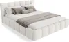 A white bouclé upholstered bed with pillows and a throw blanket. Produktbild-Vorschau