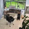 A home office setup with a computer desk, chair, and computer, next to a large window overlooking a garden. Náhled obrázku produktu