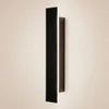 A modern, black LED wall light mounted on a textured, light-colored wall. Náhľad obrázku produktu