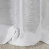 A close-up view of white sheer curtains with a textured weave, draped over a wooden floor. Produktbild-Vorschau