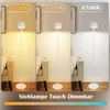 A triptych showing a white floor lamp in three different light color temperatures: warm white (3000K), neutral white (4000K), and cool white (6500K). The lamps are placed next to a beige armchair with a blanket draped over it, in a room with wooden floorin Podgląd zdjęcia produktu