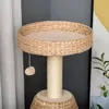 A close-up view of a cat tree with a woven basket base and a round perch. Náhled obrázku produktu