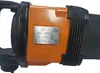 A close-up of an orange and black tool with a metal plate showing specifications. Produktbild-Vorschau