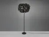 A black floor lamp with a shade made of black and gold leaves, standing on a light gray background. Voir les images du produit