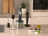A kitchen counter with a hand blender and its accessories, along with ingredients for blending. Produktbild-Vorschau