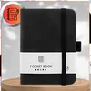 A black pocket notebook is presented on a light gray and white background, with a wooden stand at the bottom. Náhľad obrázku produktu