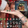 A hand holding Christmas-themed charms for a bracelet, with an advent calendar in the background. Náhľad obrázku produktu