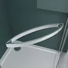 A close-up view of a modern shower enclosure handle and shower tray. Produktbild-Vorschau