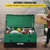 A man is placing a cardboard box into an open green outdoor storage box filled with various items like sports equipment and cushions. Produktbild-Vorschau
