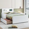 A white children's bed with storage drawers and a built-in shelf with a light. Produktbild-Vorschau