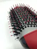 A close-up shot of a round hairbrush with black bristles and red tips. Voir les images du produit