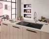 A modern kitchen island with a black sink and faucet, set against a light-colored countertop and wooden cabinets. Anteprima dell’immagine prodotto