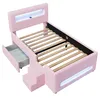 A pink upholstered bed frame with integrated LED lighting, a pull-out drawer, and a two-step staircase, shown against a white background. Náhľad obrázku produktu