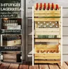 A wooden multi-tiered shelf unit designed to hold crates of drinks. The image also includes inset photos showing how different types of drink crates can be stored on the shelf. Produktbild-Vorschau