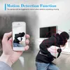 A person is holding a smartphone showing a security camera feed of a burglar. The background shows a living room with a TV. Náhľad obrázku produktu
