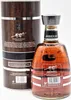 A bottle of Arehucas rum and its cylindrical presentation box are shown against a white background. Produktbild-Vorschau