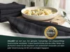 A close-up of a folded black striped kitchen towel with a bowl of pasta in the background and a 'Gastronomie Premium Qualität' badge. Produktbild-Vorschau