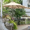 A patio scene with outdoor furniture and umbrellas. Produktbild-Vorschau