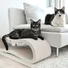 Two cats are resting on a couch and a cat scratching post. Produktbild-Vorschau