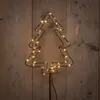 A wireframe Christmas tree decoration with LED lights against a wooden background. Produktbild-Vorschau