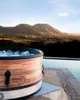 An inflatable hot tub filled with ice sits on a patio overlooking a scenic valley at sunset. Náhled obrázku produktu