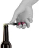 A hand opening a bottle of beer with a bottle opener. Podgląd zdjęcia produktu