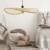 A woven pendant lamp hangs above a cozy seating area with blankets and baskets. Produktbild-Vorschau