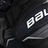 A close-up view of a black hockey chest protector with a blue geometric pattern and white branding. Anteprima dell’immagine prodotto