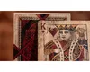 A close-up of two vintage playing cards, one face up showing the King of Hearts and the other face down showing its intricate red back design. Produktbild-Vorschau