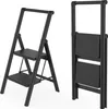 A black metal stepladder is shown in two views: one unfolded and one folded. Voir les images du produit