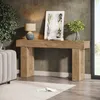 A console table with a lamp, a framed picture, and a vase of greenery. Náhľad obrázku produktu